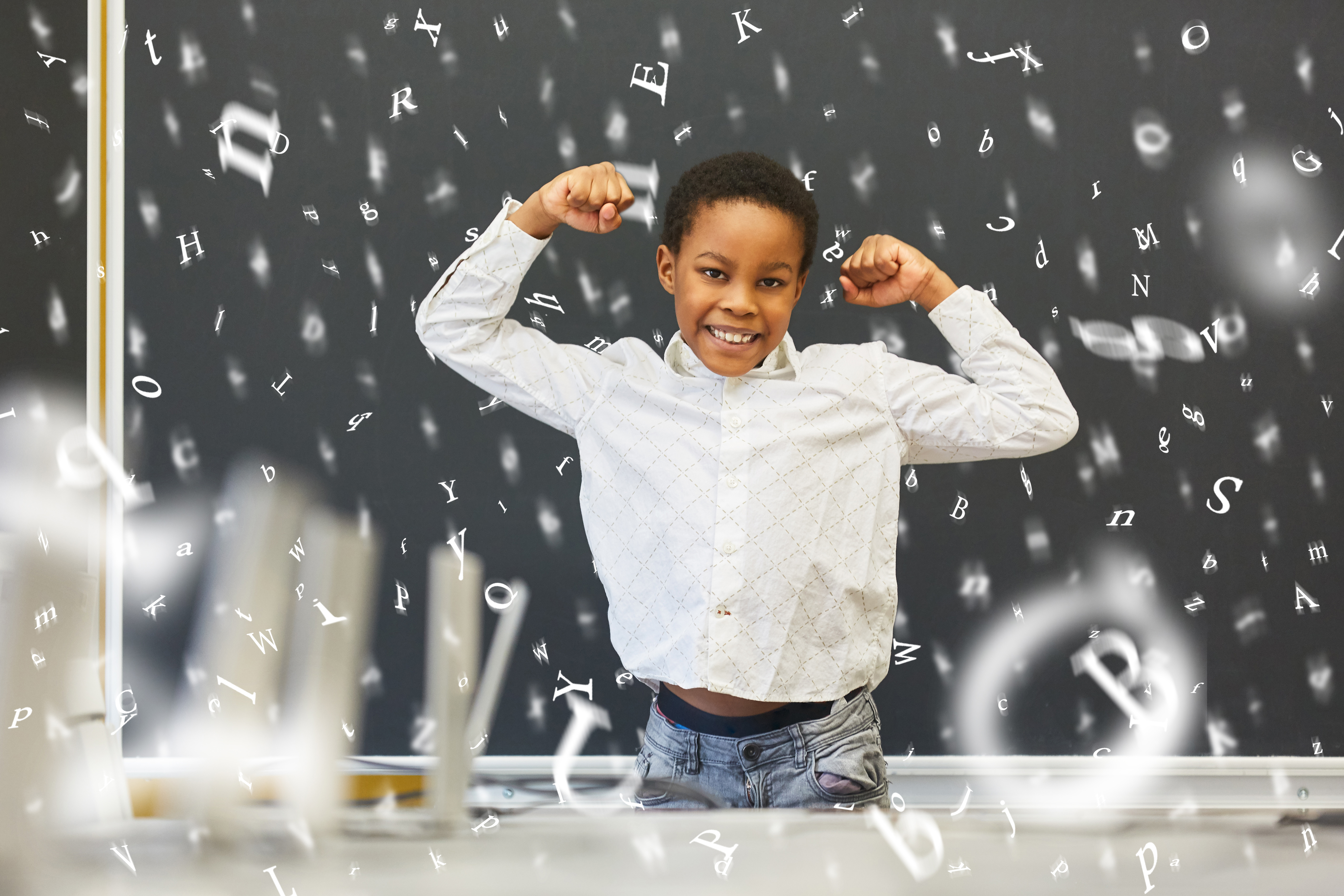 An african american student showing his muscles with falling letters around him