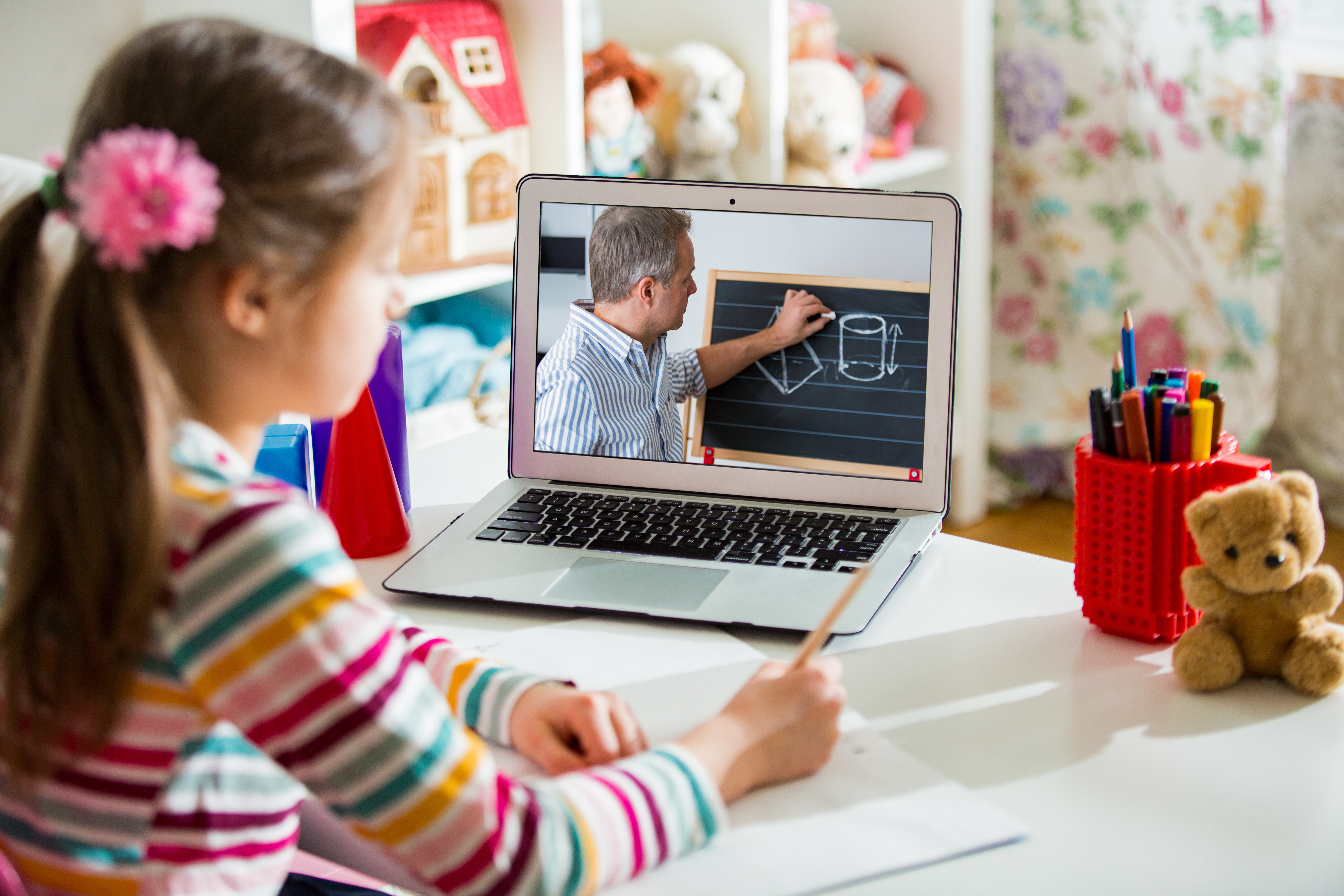 Middle-aged distance teacher having video conference call with pupil using webcam. Online education and e-learning conce Home quarantine distance learning and working from home.