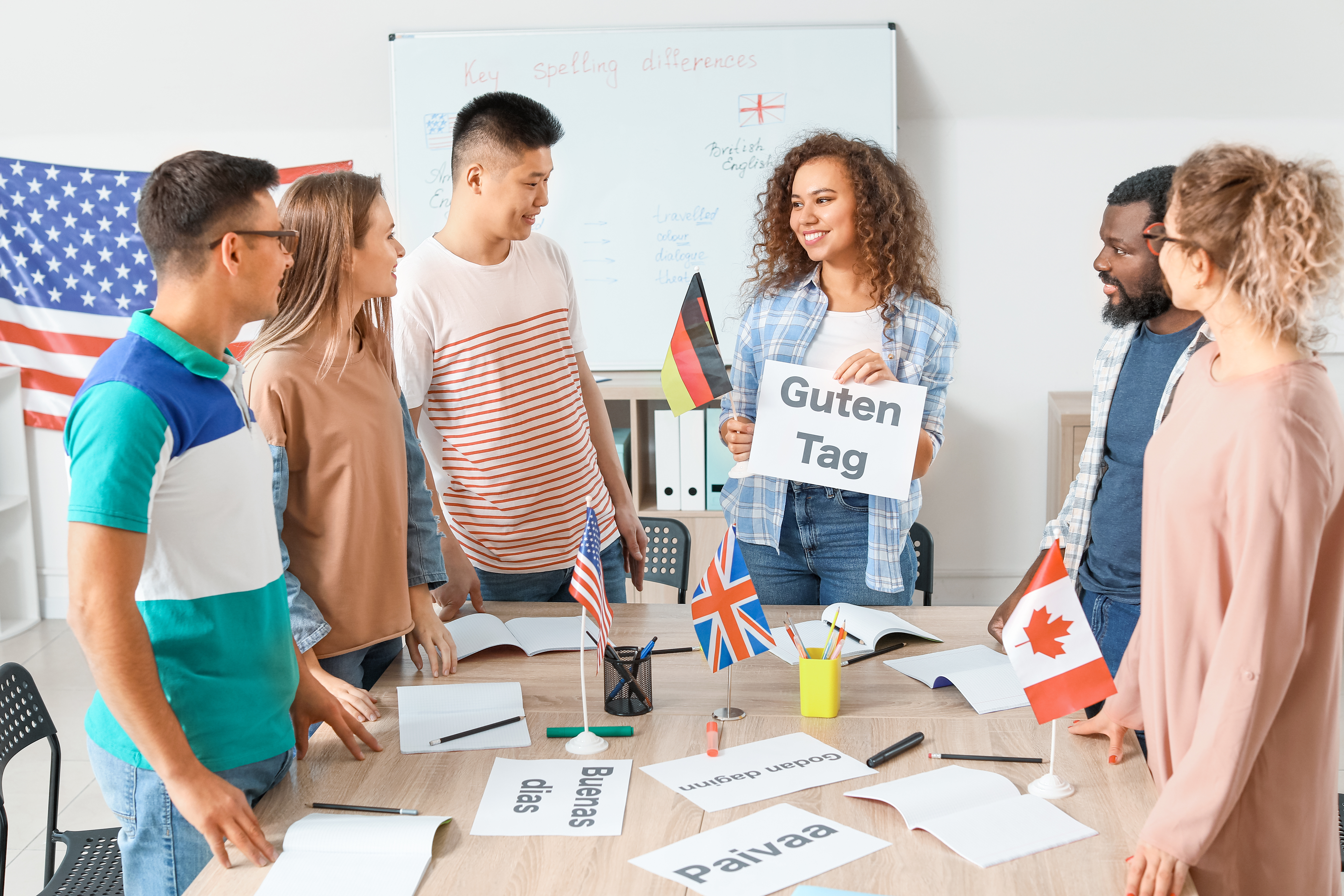 High school students around a table with different country flags