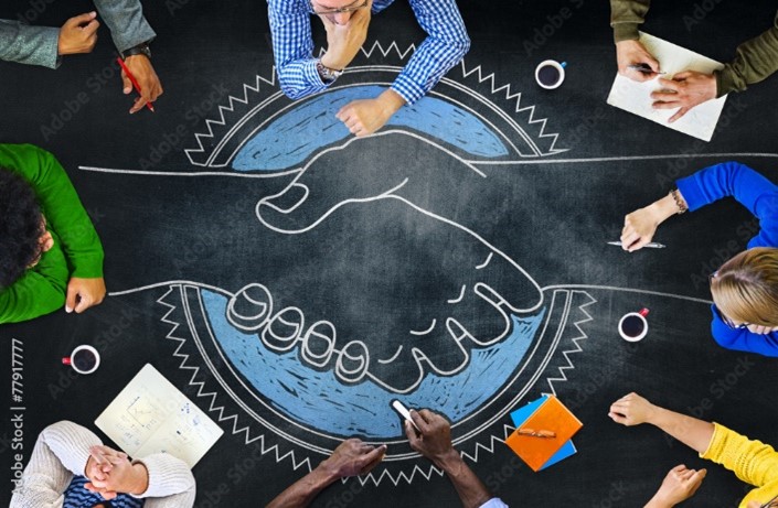 elementary students sitting in a circle playing with chalk