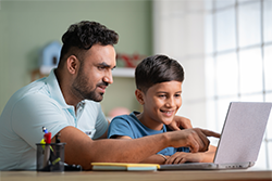 Father and Son working on the computer