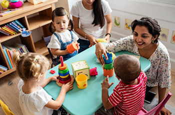 Teacher playing with children