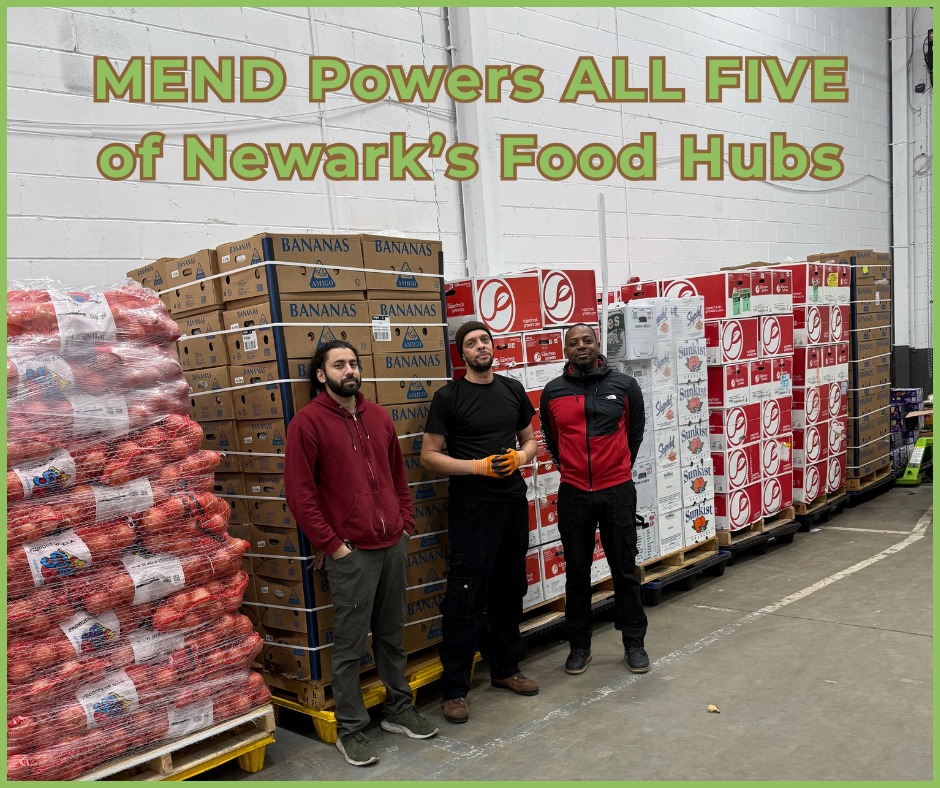 three men standing in front of produce