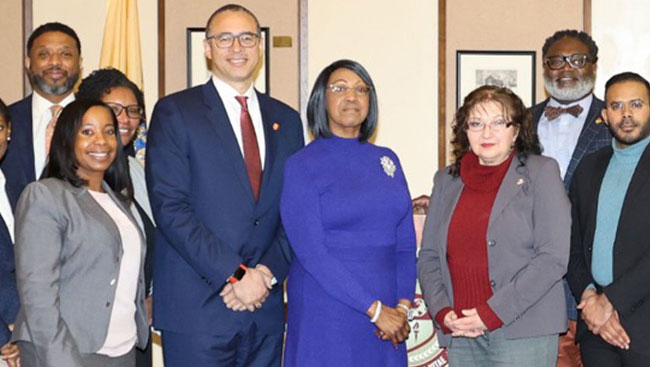 photo: Governor Sheila Oliver, table, member of WDTF