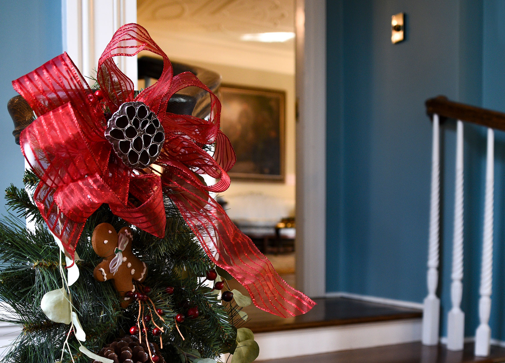 A large red silky bow and evergreens decorate the banister leading to The West Trenton Garden Club