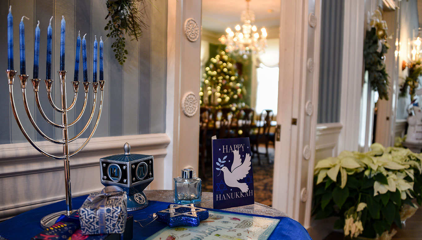 photo - jpg   Drumthwackets welcoming Foyer, featuring a Menorah honoring Chanukah, on a sideboard at a doorway to the Dining Room. Decor by Keyport Garden Club.