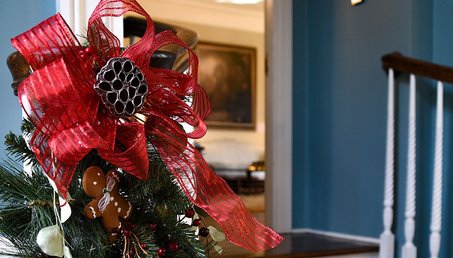 photo - A large red silky bow and evergreens decorate the banister leading to The West Trenton Garden Club