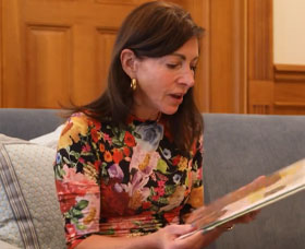 First Lady holding the book