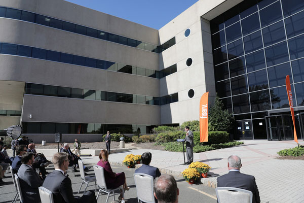 Photo of Governor Phil Murphy speaking at lecturn in front of Fiserv building