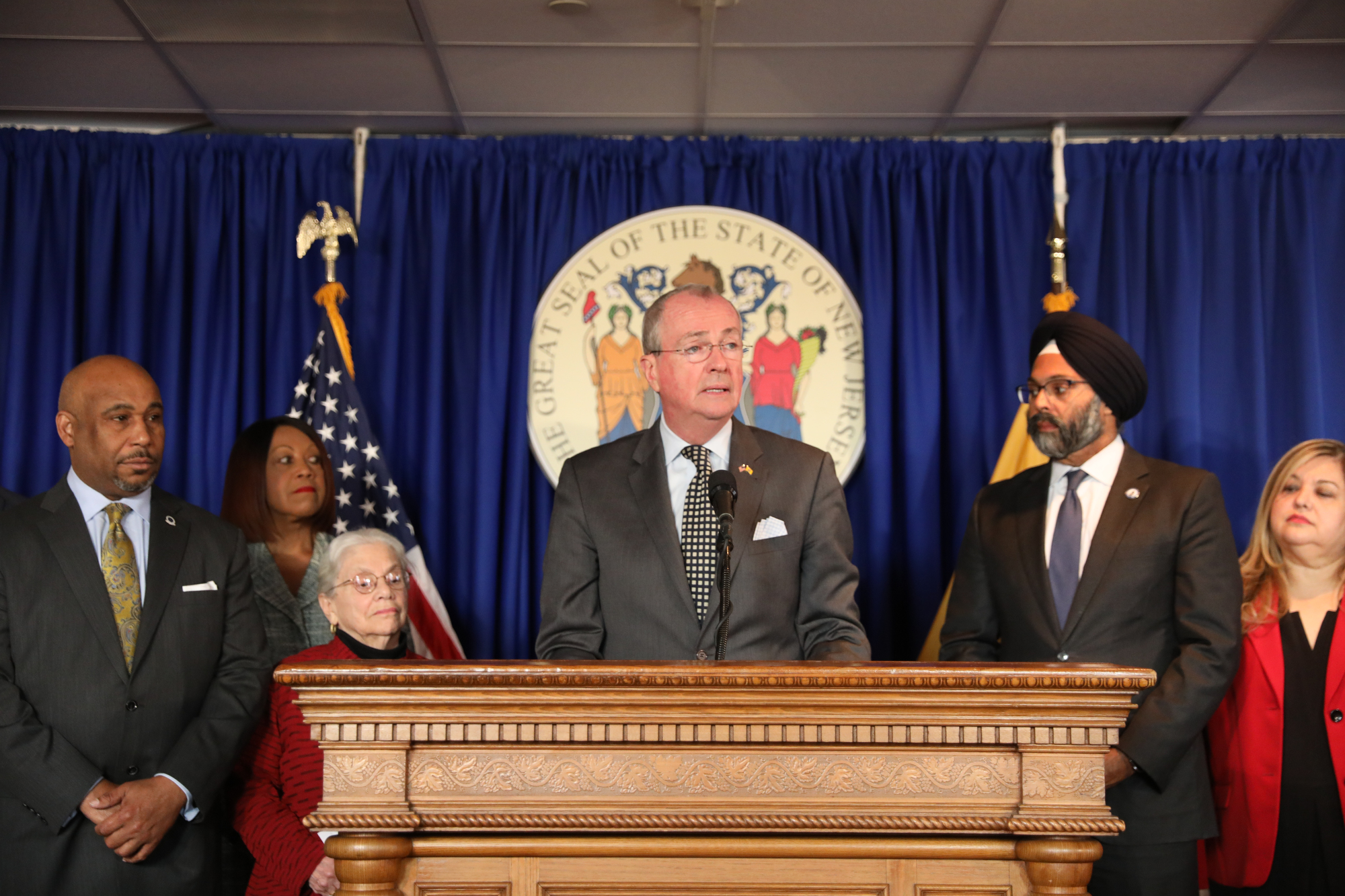 photo: Governor Phil Murphy, Gurbir S. Grewal, Deborah Poritz, Senator Sandra Cunningham, Senator Nellie Pou Jiles Ship, and Acting Commissioner of Corrections Marcus Hicks