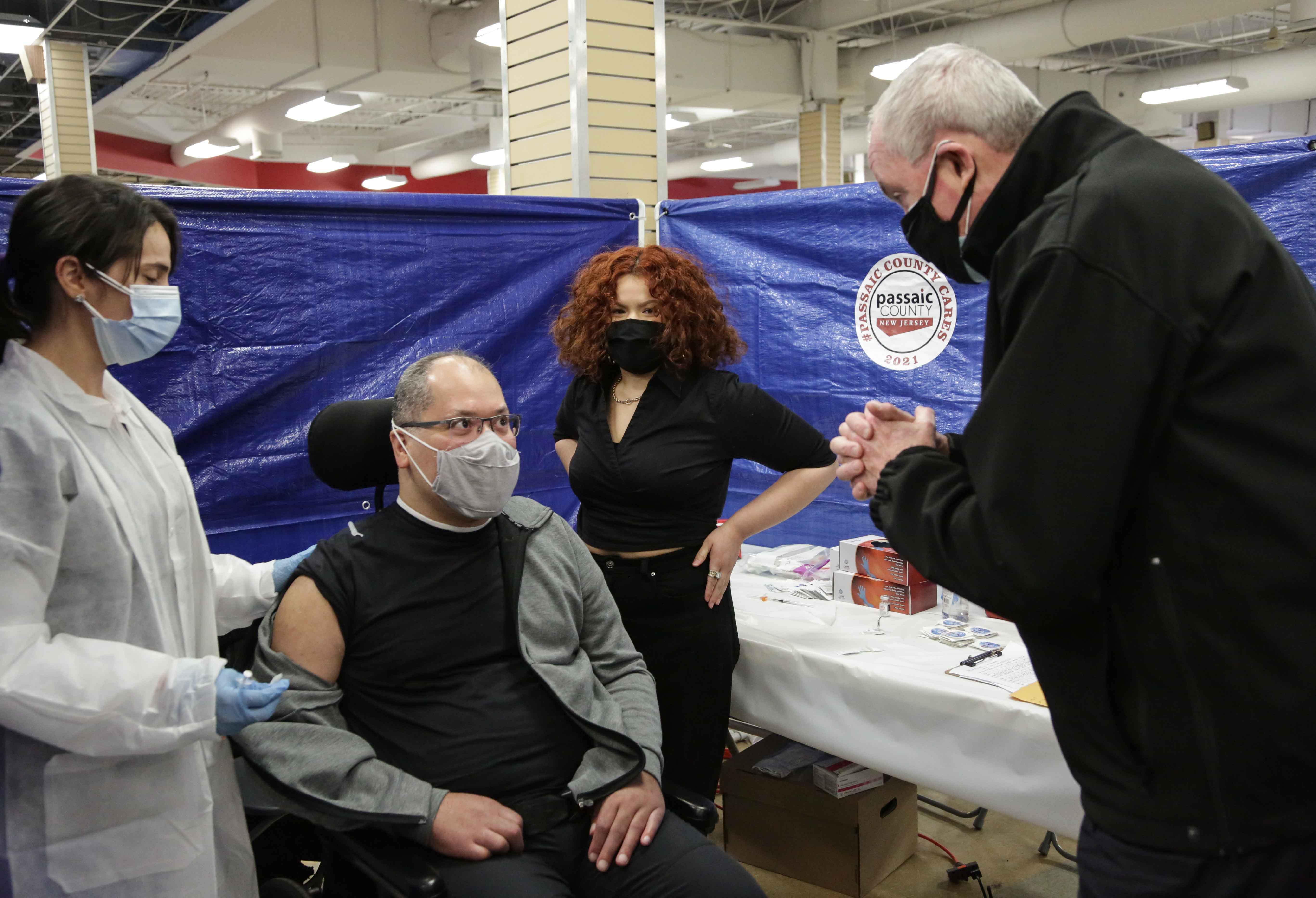 photo: Governor Murphy at Vaccination Center standing next to a patient