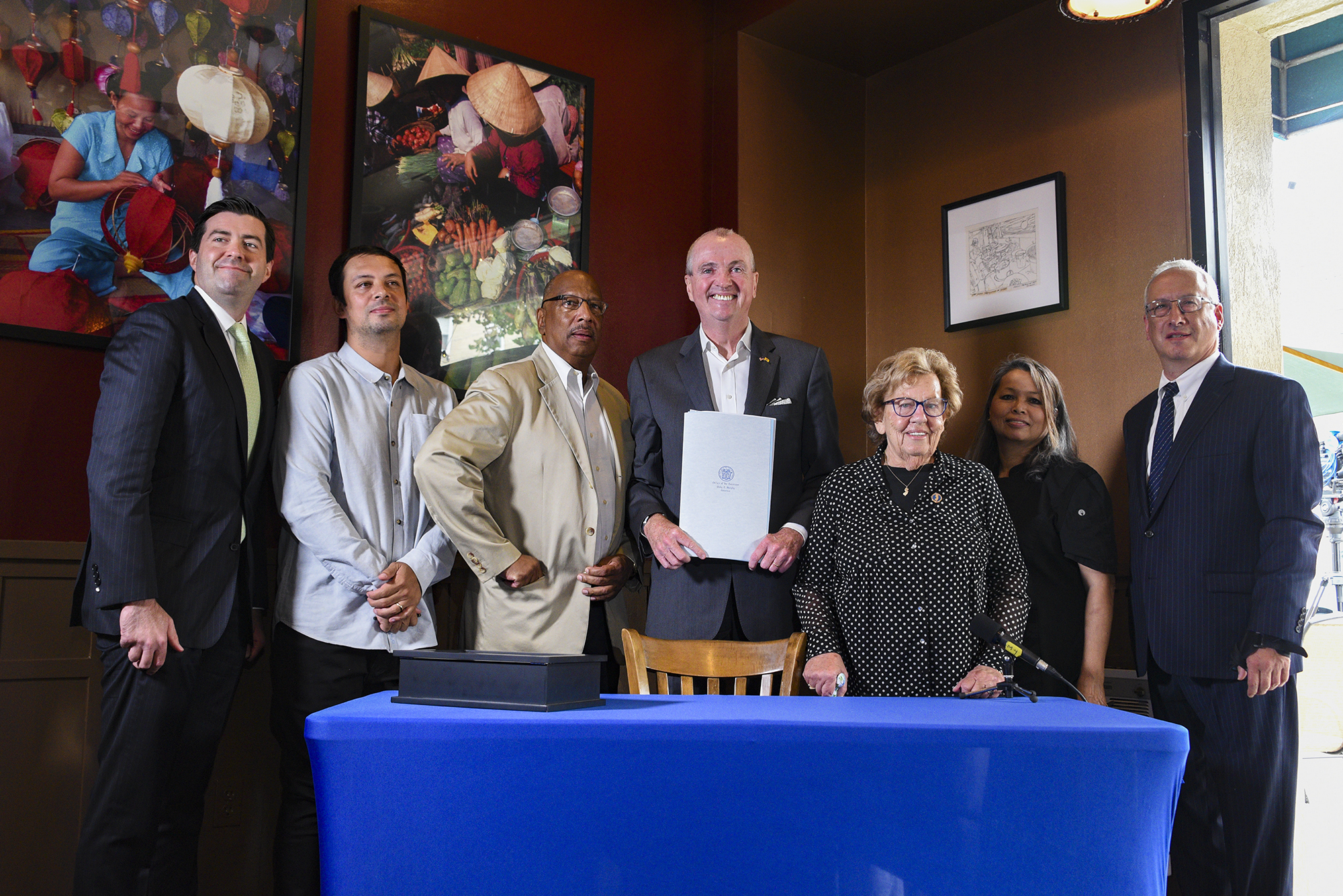 photo: Governor Murphy holding the signed bill