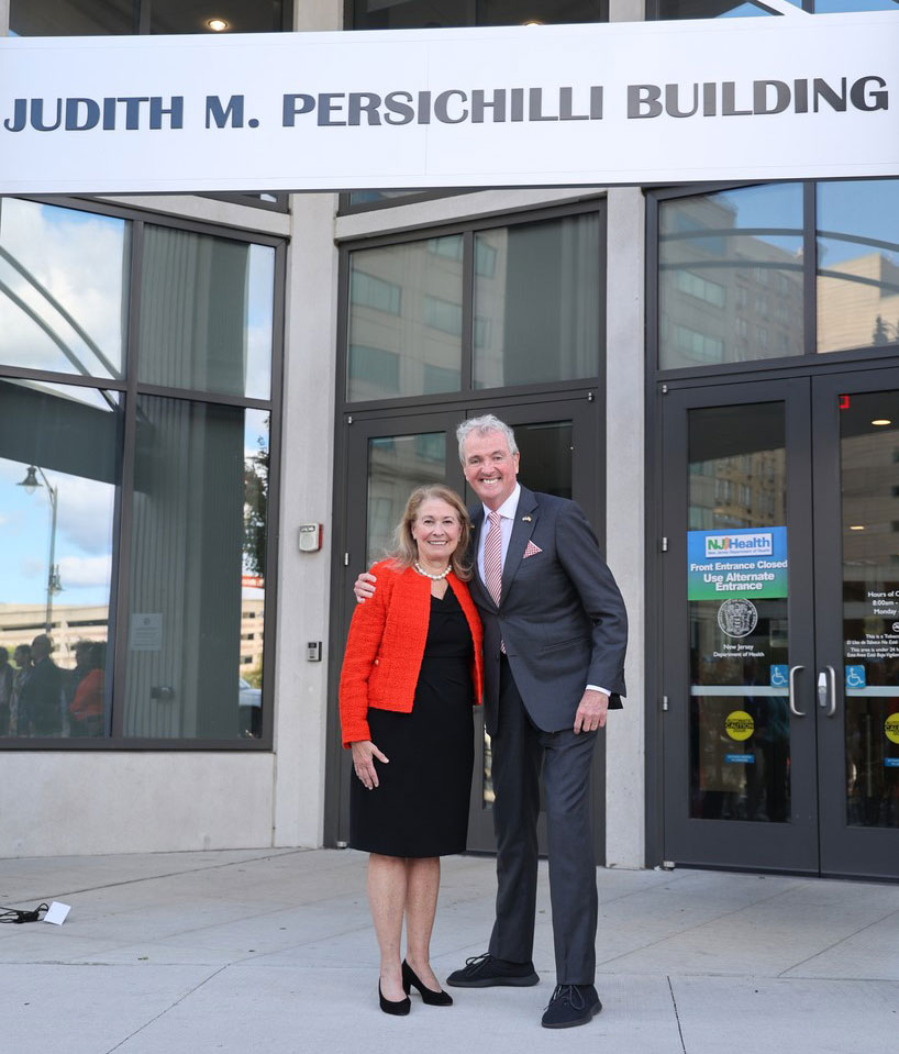 photo - Governor standing on the front of a building with Commissioner Persichilli