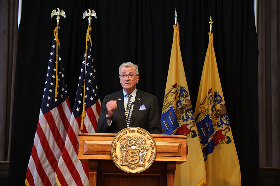photo: overnor Phil Murphy , flags of NJ and USA behind him