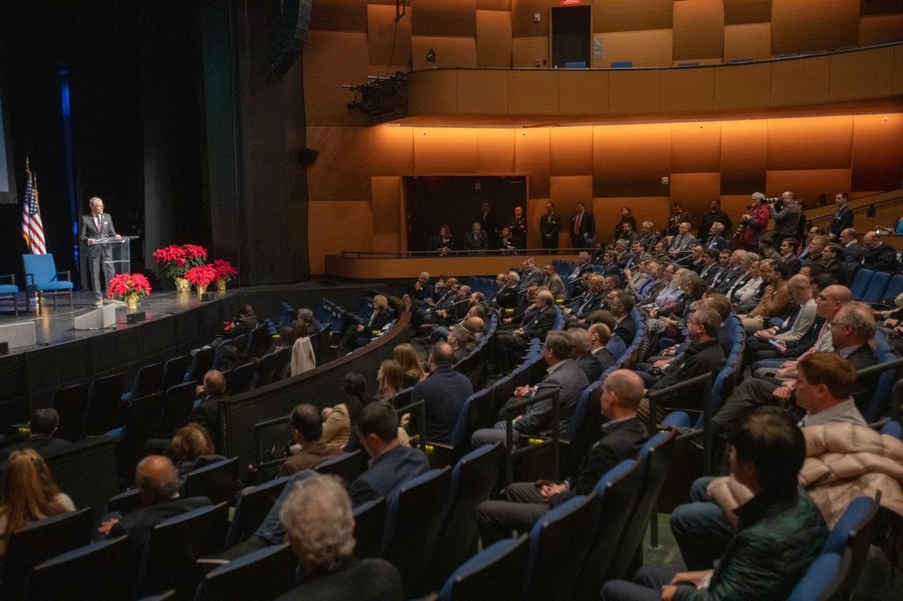 Photo: Governor Murphy is giving a speech in a big hall with dozens of people