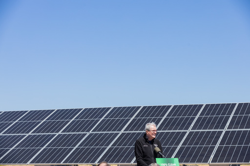 Governor Murphy in front of a Large Solar Panel