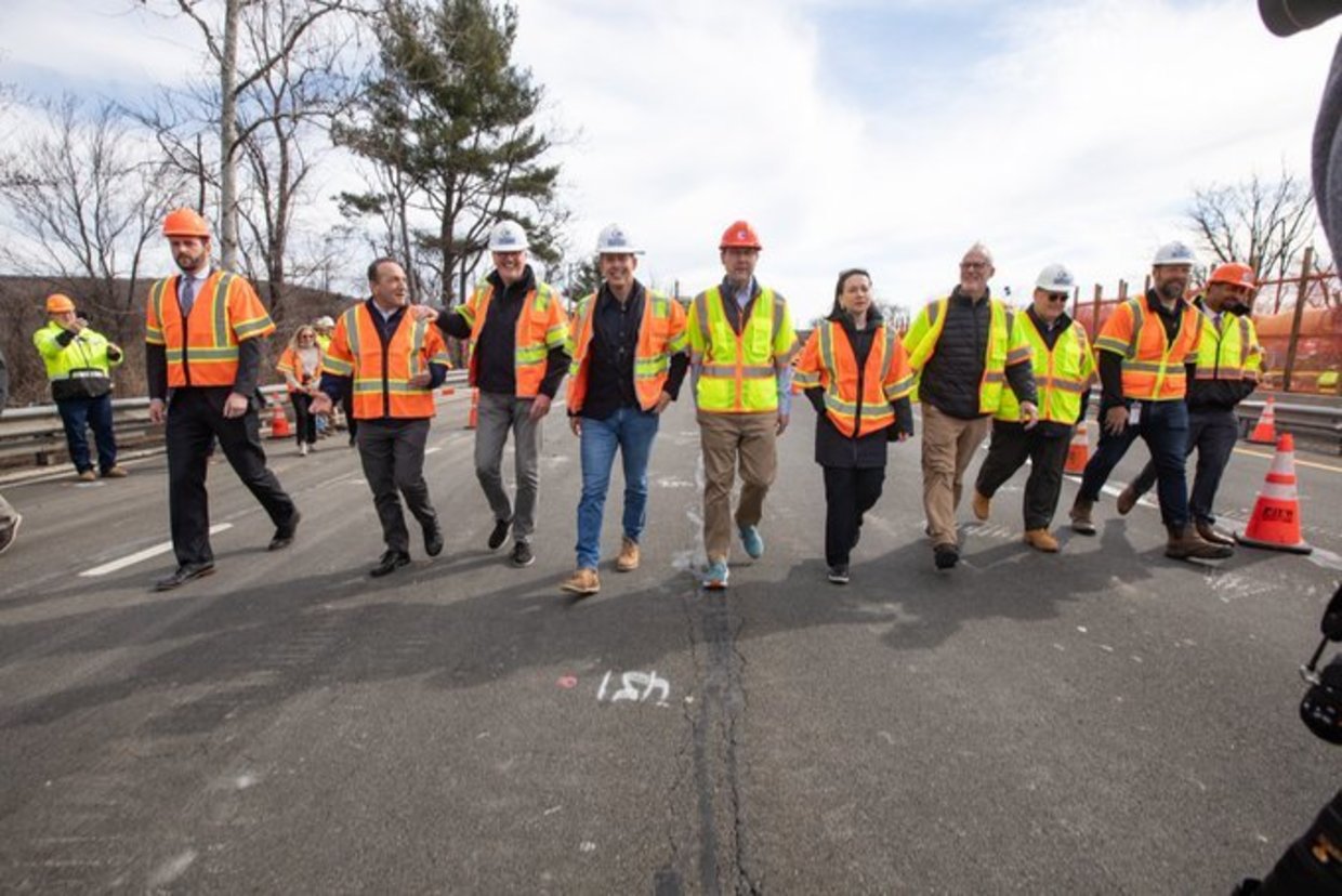 Photo: Governor Murphy walking on the road with construction workers