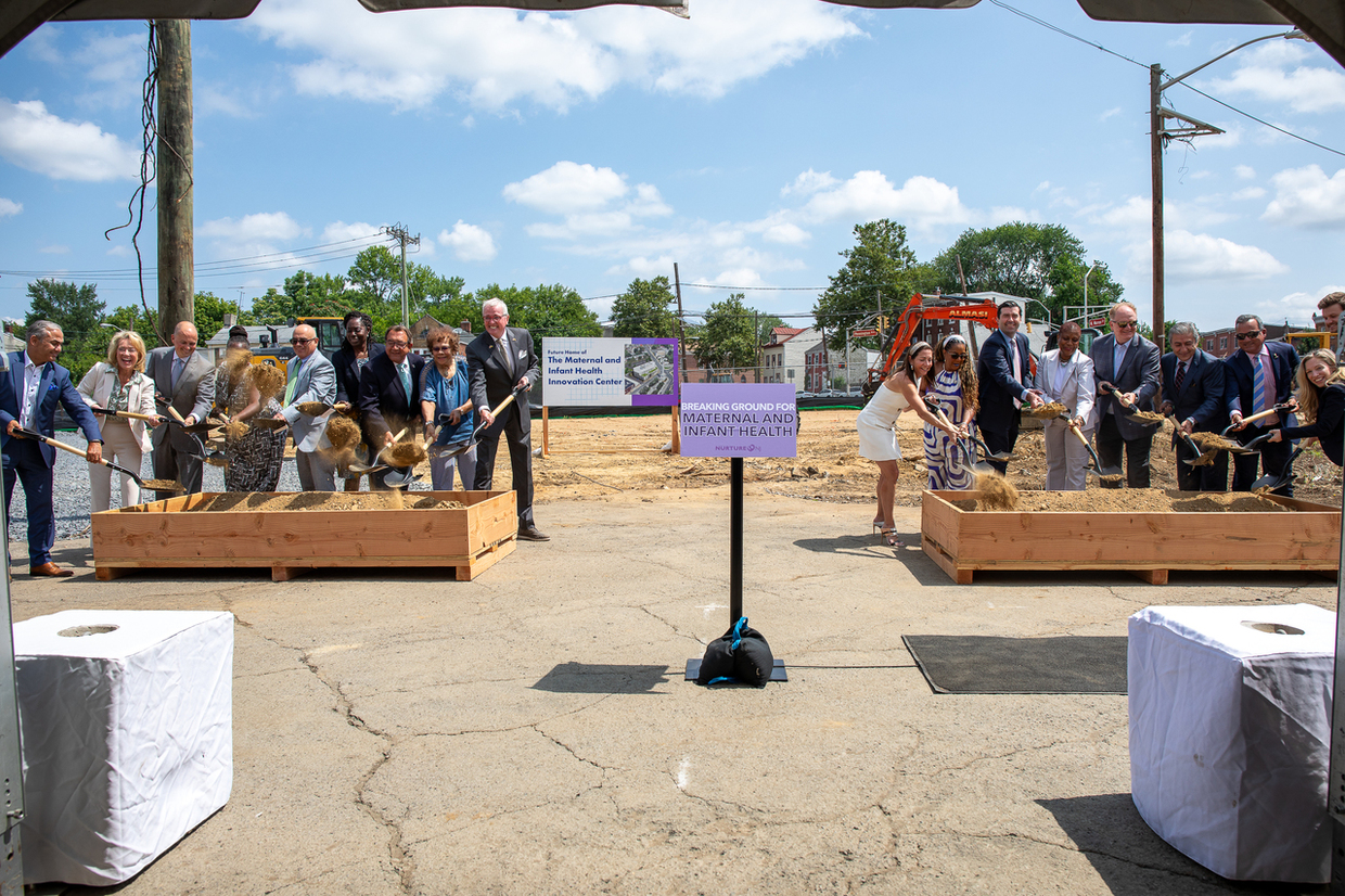 Governor Murphy and others holding shovels in front of the construction site