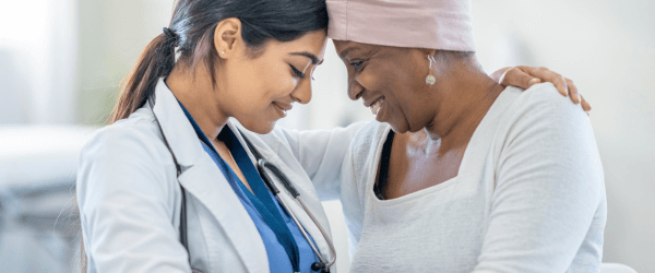 A doctor consoling her patient.