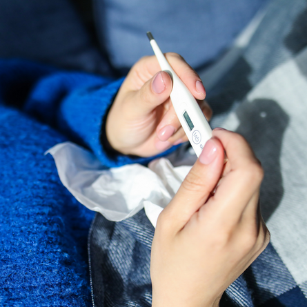 Person holding a thermometer