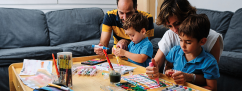 Parents doing arts and crafts with their two children