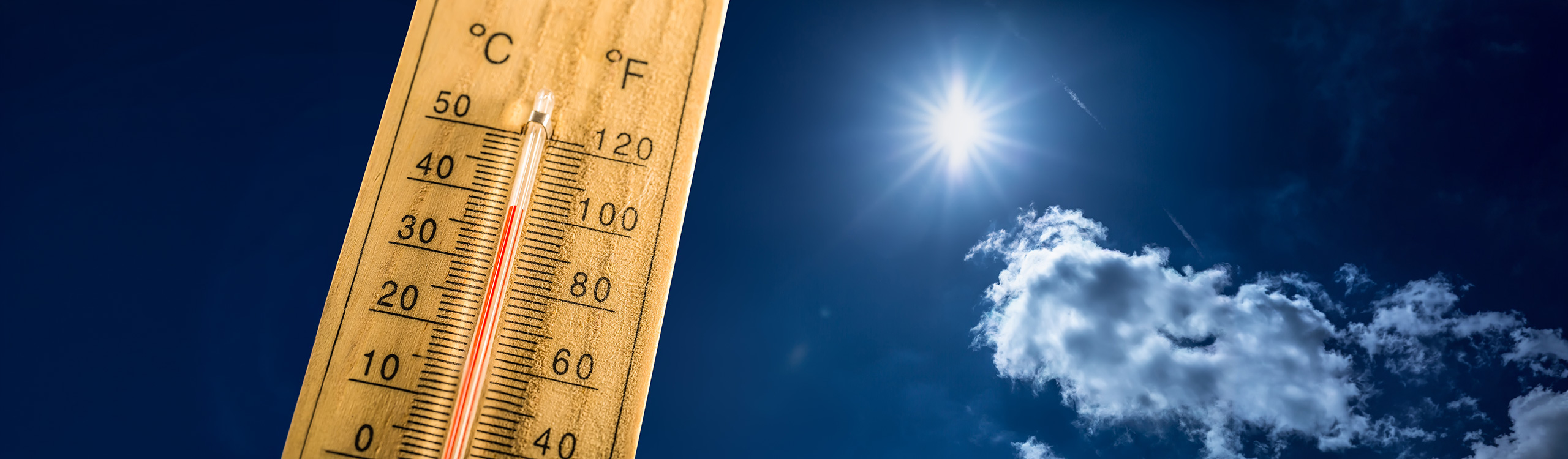 Thermometer in front of open skies