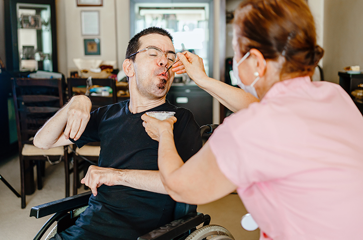 Pic of Women assisting a person on a wheelchair
