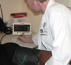 nurse checking blood pressure