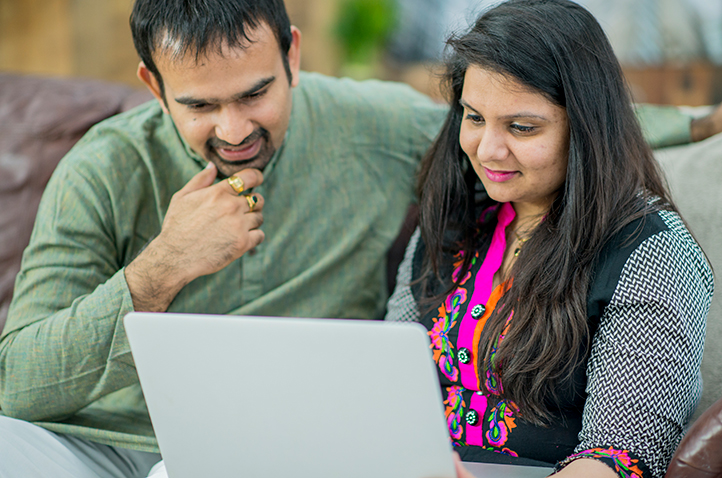 photo: couple stering at laptop screen