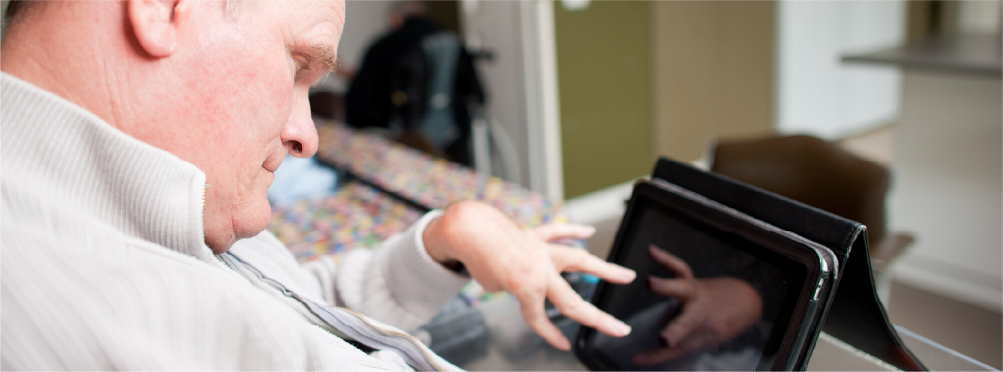 A man with disability using a tablet 