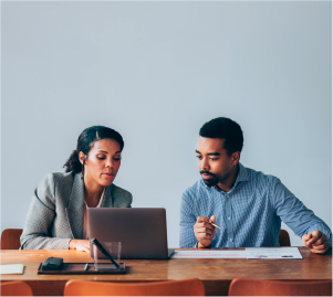 Man and woman looking into the laptop