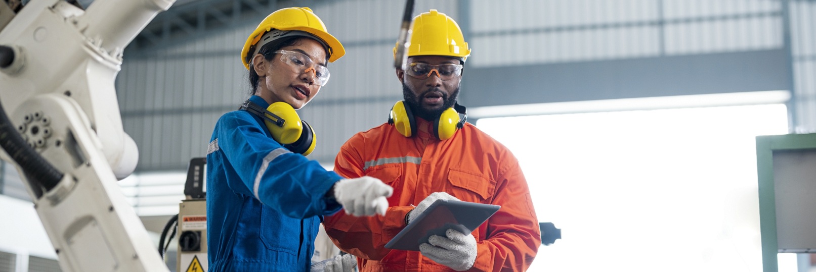 factory workers looking at tablet together