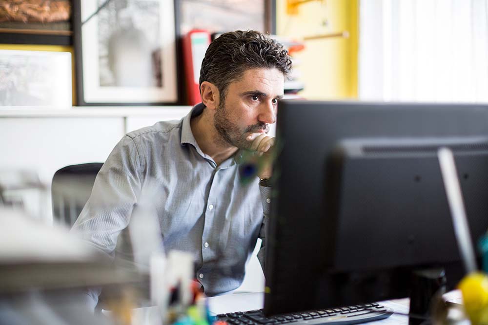 A concerned business owner sitting at a desk