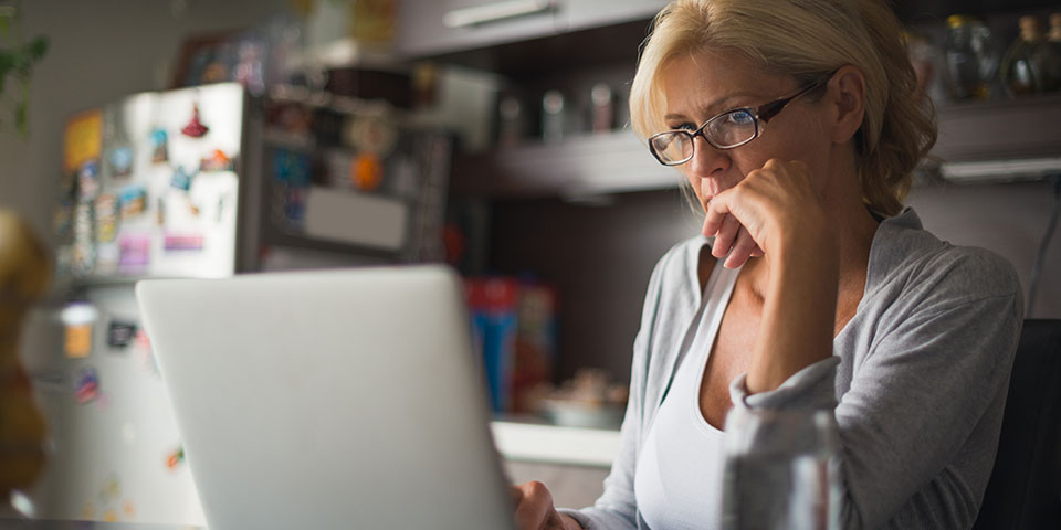 woman at a computer in her kitchen