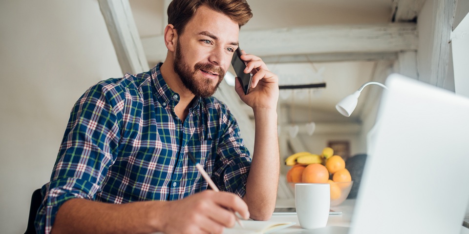 man on phone at laptop