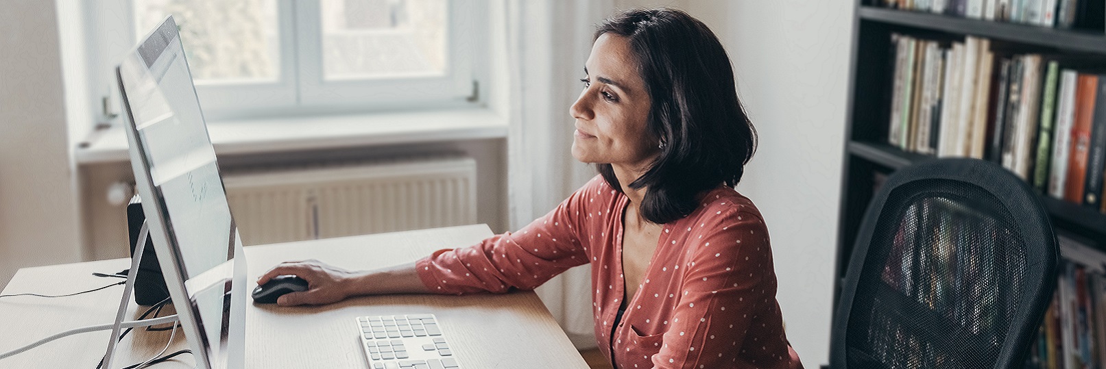 Woman sitting at desktop computer. 