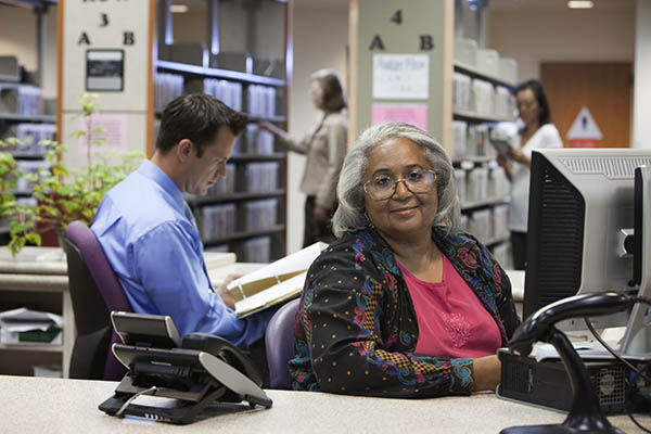 a senior woman working in a library