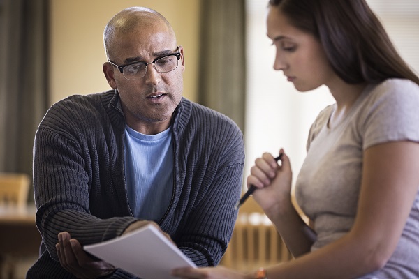 man looking over document with woman