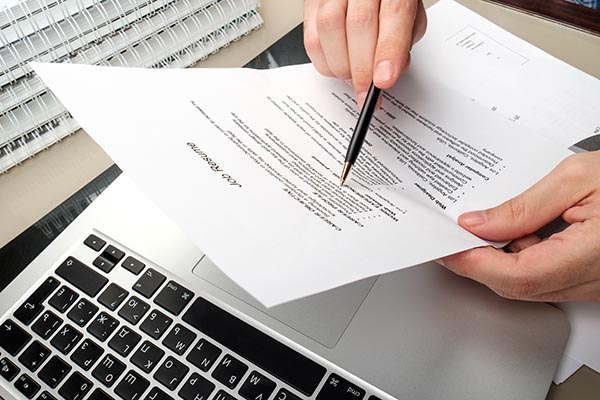 a person reviewing a printed resume