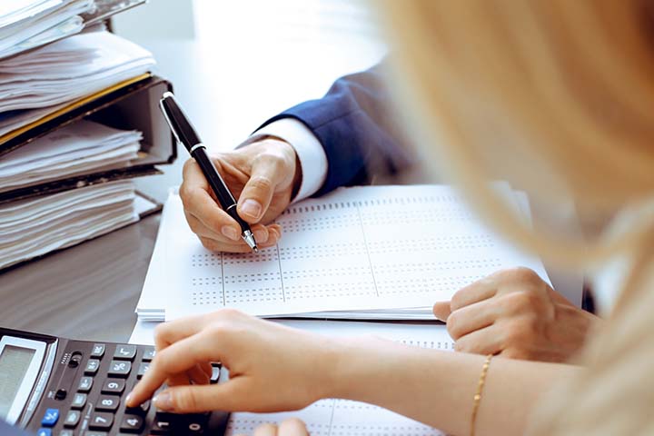 accountants looking at printouts on a desk