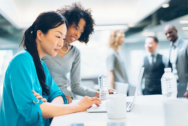 two women working together in an office