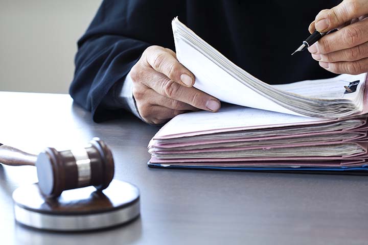 judge signing papers in his chambers