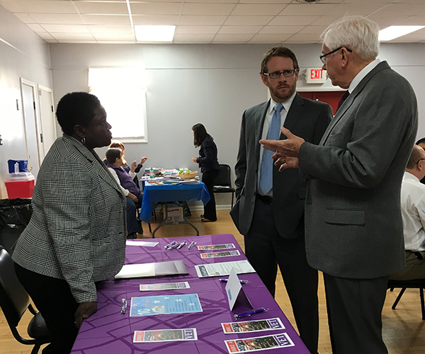 Labor Department Chief of Staff Gregory Townsend (center) discusses veterans services with Veterans Business Representative Veronica Jones and State Veterans Program Coordinator Wayne Smith at the Middlesex County Veterans Job and Services Fair. 