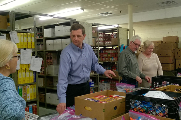 Acting Labor Commissioner Aaron Fichtner (blue shirt) helps volunteers assemble packages for Sussex County families in need as part of Governor Christie’s Season of Service.