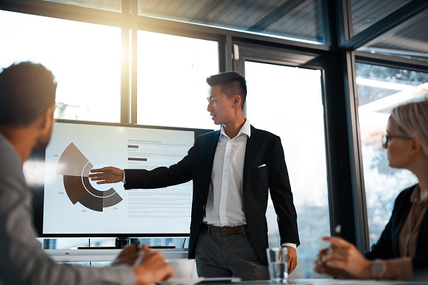 Professional giving a presentation to his colleagues in an office