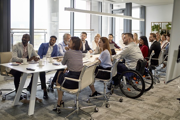 Diverse group of professionals sitting together at conference table