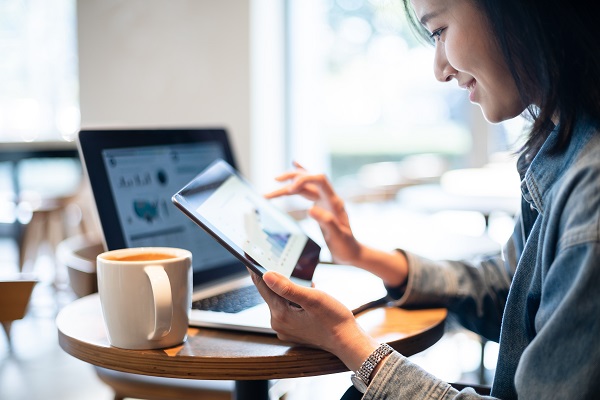 Woman using digital tablet in cafe