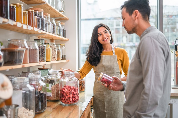 Employee showing products to costumer in store