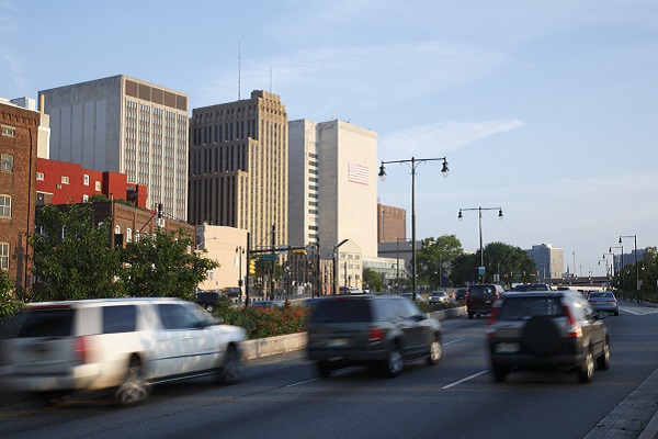 Newark, NJ with assorted cars traveling by office buildings in a downtown area