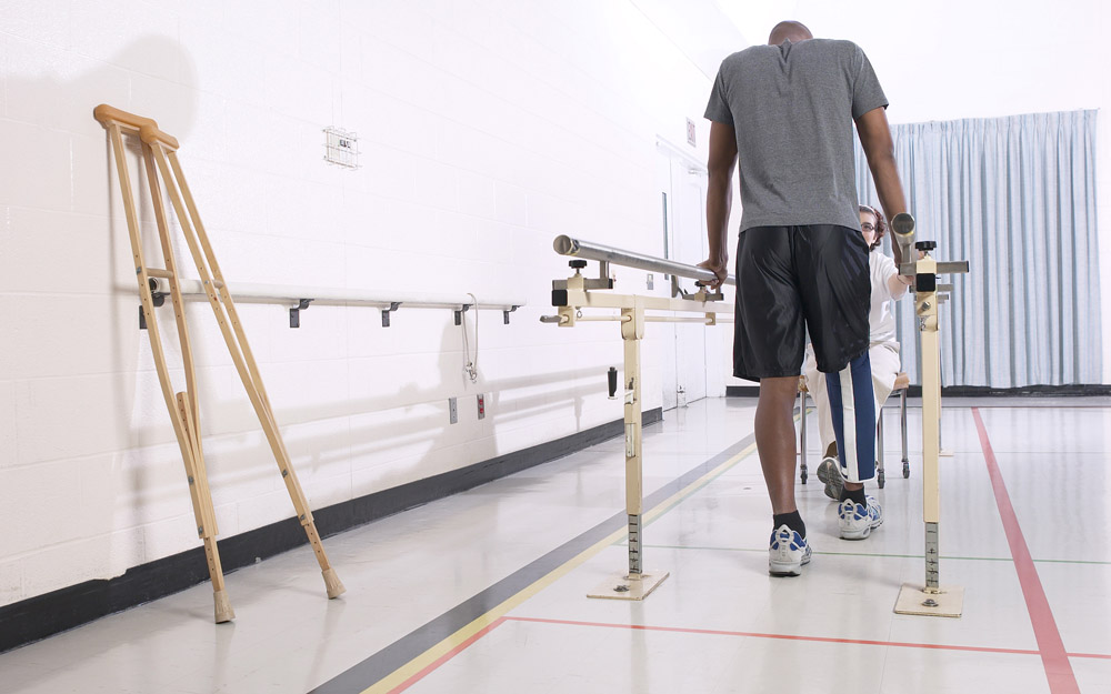 An African-American man with an injured leg doing physical therapy